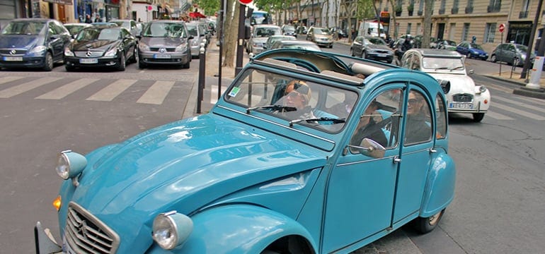 Couple in a 2cv driving in Paris